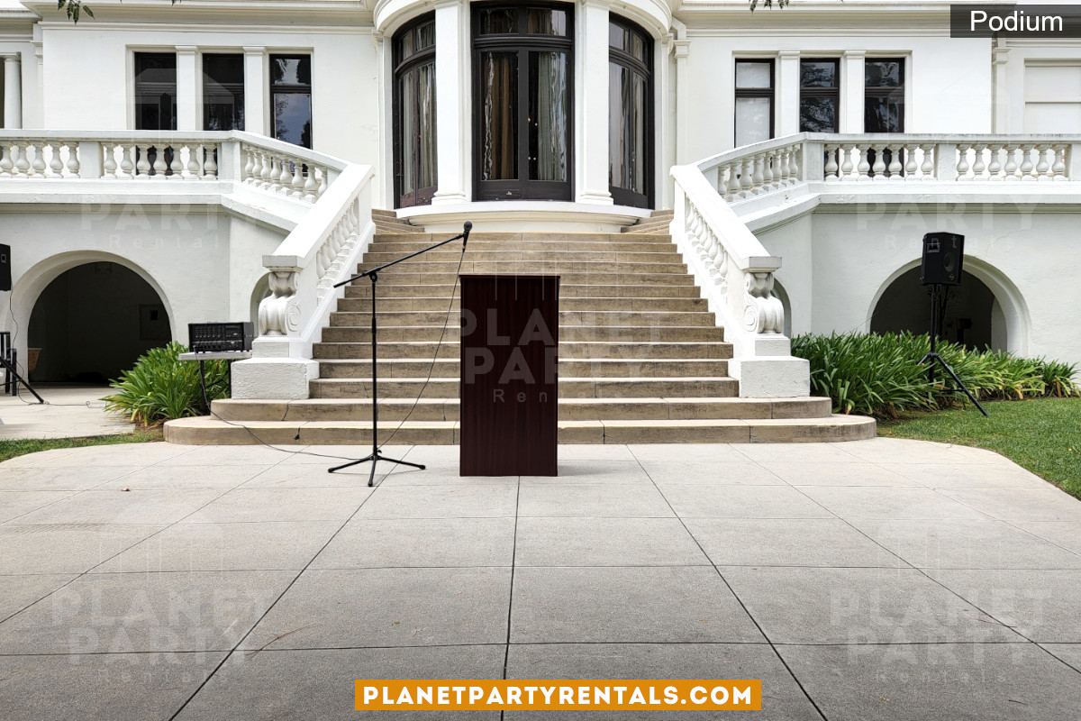 Podium in front of mansion next to microphone