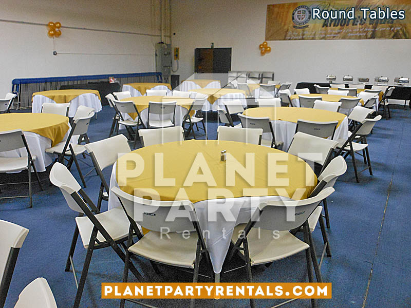60” Round plastic table with white tablecloths and yellow overlay with white chairs