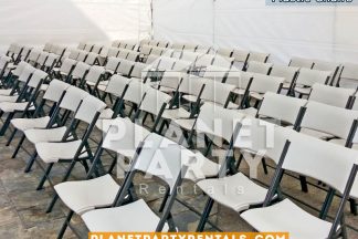 White plastic chairs inside of a white tent