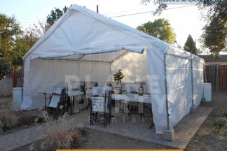 20ft x 20ft Tent with Sidewalls with tables and chairs | San Fernando Valley Tent Rentals