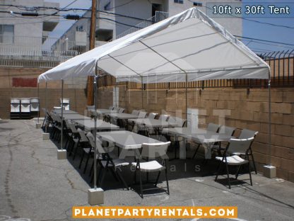 Rectangular Tables and Plastic Chairs underneath White Tent