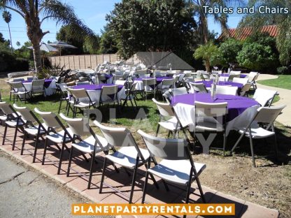 White plastic chairs with round table with white table cloth and purple overlay/diamond