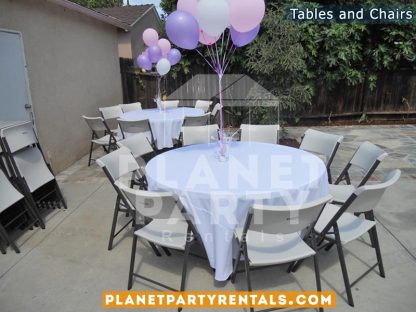 White plastic chairs with round table with white table cloth